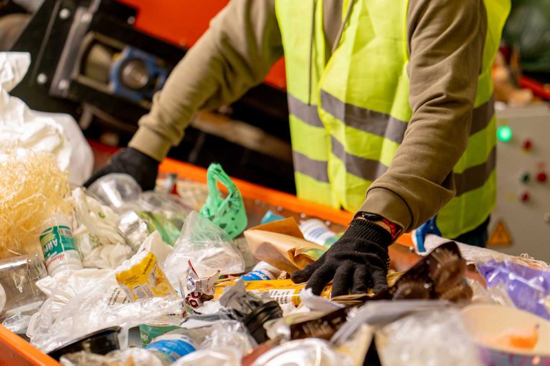 Hands sorting recyclable materials